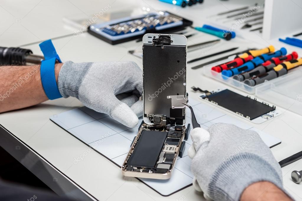 Technician replacing a smartphone screen